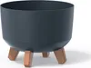 A dark gray planter pot with three brown legs, shown against a white background. Podgląd zdjęcia produktu