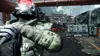 A soldier in a futuristic suit stands in a gritty, industrial environment. Produktbild-Vorschau