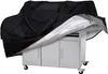 A black grill cover is partially covering a silver grill cart. Náhľad obrázku produktu