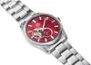 A close-up, angled shot of a men's wristwatch with a red dial and a silver metal band, set against a white background. Podgląd zdjęcia produktu