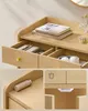 Collage of close-up images of a light wood dresser with drawers, shelves, and accessories, highlighting its features. Produktbild-Vorschau