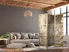 A living room scene with a sofa, ottoman, and a room divider. Produktbild-Vorschau