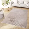 A modern living room with a sofa, armchair, coffee table, and a rug. Produktbild-Vorschau