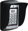 A black weather-protective cover over a silver keypad with numbers and buttons. Náhľad obrázku produktu