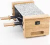 A close-up, angled shot of a small, wooden electric raclette grill with a granite cooking surface. Náhľad obrázku produktu