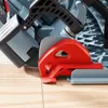 Close-up of a red clamp mechanism on a gray power tool resting on a wooden surface. Produktbild-Vorschau
