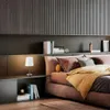 A bedroom scene with a bed, nightstand, and lamp. Podgląd zdjęcia produktu