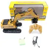 A remote-controlled excavator toy, its remote control, and accessories are displayed on a white background, with the product's packaging visible in the background. Náhľad obrázku produktu