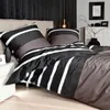 A bedroom scene with a bed dressed in striped bedding. Produktbild-Vorschau