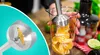 A close-up of a blender blade and a hand holding a blender in a beaker with orange slices. Produktbild-Vorschau