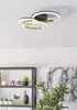 A modern ceiling light fixture with three interlocking rings, mounted on a white ceiling. Produktbild-Vorschau