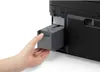 A hand is inserting a gray tray into a black printer. Náhled obrázku produktu
