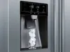 Close-up of a refrigerator's ice and water dispenser with a glass of ice. Produktbild-Vorschau