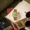 A vintage gold Casio watch is placed on top of several books, with sunglasses and a leather pouch nearby. Voir les images du produit