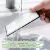 A hand is holding a white filter under running water in a sink. Produktbild-Vorschau