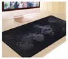 A large black mouse and keyboard mat with a world map design is placed on a desk in front of a computer monitor. Náhled obrázku produktu