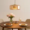 A dining table set for a meal, with a pendant light above. Anteprima dell’immagine prodotto