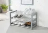 A multi-tiered shoe rack with various shoes on each level, placed in a domestic setting near a window. Produktbild-Vorschau