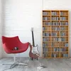 A red chair, an electric guitar, and a bookshelf filled with CDs in a room. Náhled obrázku produktu