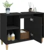A black washbasin cabinet with wooden legs, shown with some decorative items and toiletries on top and inside. Náhled obrázku produktu