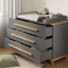 A baby changing dresser with drawers open, showing clothing inside. Náhled obrázku produktu