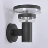 A modern anthracite LED outdoor wall light mounted on a white wall. Produktbild-Vorschau