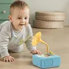 A baby is crawling on the floor and interacting with a toy gramophone. Náhľad obrázku produktu