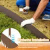 A person installing a metal garden border into the ground next to grass and plants. Voir les images du produit