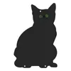 A black cat silhouette with green eyes on a white background. Voir les images du produit