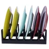 A dish rack holding several colorful plates. Produktbild-Vorschau