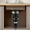 A garbage disposal unit installed under a kitchen sink. Voir les images du produit