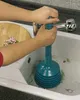A person is using a blue plunger in a kitchen sink. Produktbild-Vorschau