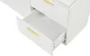 A close-up view of an open drawer on a white cabinet with gold handles. Produktbild-Vorschau