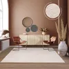 A living room scene featuring a rug, chairs, and a sideboard. Produktbild-Vorschau