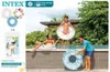 Children playing with inflatable swim rings by a pool. Anteprima dell’immagine prodotto