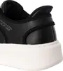 A close-up view of the heel and sole of a black Skechers slip-on shoe. Produktbild-Vorschau