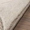 Close-up view of a rug's edge on a wooden floor. Anteprima dell’immagine prodotto