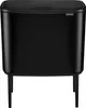 A black Brabantia Bo Touch Bin trash can with a lid, standing on four legs. Produktbild-Vorschau