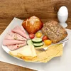 A plate of breakfast food including bread rolls, cheese, cold cuts, cucumber, tomatoes, and an egg in an egg cup. Anteprima dell’immagine prodotto