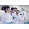 Four scientists in a lab looking at a computer screen. Produktbild-Vorschau