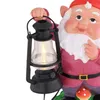 A close-up of a garden gnome holding a lantern. Produktbild-Vorschau