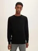 A man wearing a black sweater and grey jeans, posing for a product shot. Produktbild-Vorschau