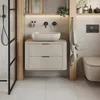 A modern bathroom with a wall-mounted vanity, sink, toilet, and shower. Anteprima dell’immagine prodotto