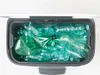 A top-down view of a dark gray trash can filled with crushed green plastic bottles. Náhľad obrázku produktu