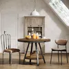 A dining set in a room with a slanted ceiling and a window. Produktbild-Vorschau
