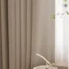 Close-up of a beige curtain with a white ribbon on a windowsill. Produktbild-Vorschau