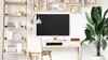 A modern home office setup with a desk, chair, shelves, and a large plant. Podgląd zdjęcia produktu