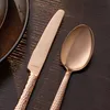 A close-up shot of a knife and spoon from a cutlery set, placed on a dark wooden surface. Náhľad obrázku produktu