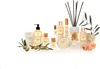 A collection of luxury bath and body products, including perfumes, lotions, and soaps, arranged with olive branches and flowers. Náhled obrázku produktu