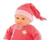 Close-up of a baby doll wearing a pink hat and outfit. Produktbild-Vorschau
